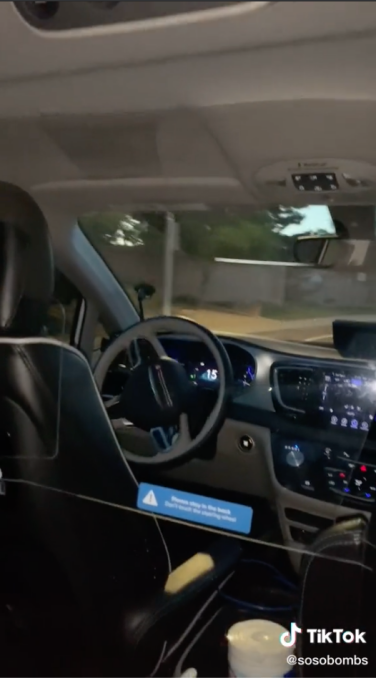 A TikTok screenshot showing the inside of a driverless Waymo minivan.